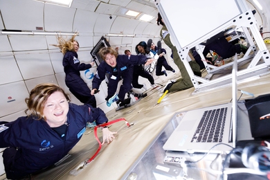 Noelle Bryan and Maria Zuber monitor their experiment while floating in zero gravity.
