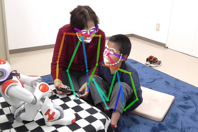 An example of a therapy session augmented with humanoid robot NAO [SoftBank Robotics], which was used in the EngageMe study. Tracking of limbs/faces was performed using the CMU Perceptual Lab's OpenPose utility.