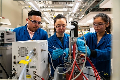 Left to right: Sebastian Esquivel, Jenna Ahn, and Crystal Chen break down whey, normally a byproduct, into components for use in animal feed. 