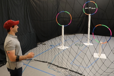 Lead author Joseph DelPreto controls a "Conduct-A-Bot" drone with his arm muscles.