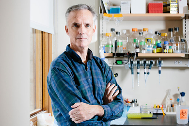 Portrait photo of Jim Collins in a wet lab