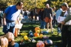 Visitors to a glass pumpkin patch staged by BAGI (the Bay Area Glass Institute) in California admire the work and choose their pumpkins carefully (above). The photo at right shows a selection of glass pumpkins from an earlier BAGI show. The Great Glass Pumpkin Patch will appear on Kresge Oval next Saturday and Sunday from 9 a.m. to 5 p.m.