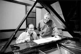 Charles Shadle (left), composer of "Coyote's Dinner," and Michael Ouellette, who wrote the libretto for the one-act opera, review the score. Both are lecturers in the music and theater arts section.
