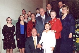 Professor Paul E. Gray and Priscilla K. Gray,  surrounded by their children and grandchildren at a ceremony renaming the President's  House to Gray House.