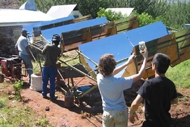 Interns at Appropriate Technology Services in Lesotho work with graduate student Amy Mueller, second from right, and sophomore Perry Hung, right, on the MIT solar micro-generator in January.
