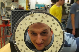 Graduate student Michael Short poses with his LEDStorm On-Camera ring light in the MIT Hobby Shop.  