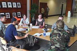Marc Zissman (in orange and blue cap) attends a meeting at the U.S. embassy in Port-au-Prince to plan activities for assessment of the military's Haiti relief operation.