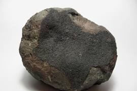 One of the thousands of fragments recovered from the Allende meteorite, which fell in Mexico in 1969. The black area is a fusion crust, produced from the heat of slamming into Earth's atmosphere. New studies of one such fragment provided evidence that the object the meteorite originated from had a magnetic field.