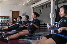Students sit ready at the 'finish,' a specific technique of the rowing stroke at the Pierce Boathouse.