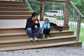 Junior David Chang and a young camper share a quiet moment at Camp Kesem.