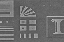 A glass stamp reproduces precise, nanometer-scale etchings in silver. The original engraving, pictured above, is 10 microns wide — less than a quarter of the diameter of a human hair.