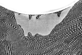 This electron-microscope image of a cross-section of a layered polymer shows the crater left by an impacting glass bead, and the deformation of the previously even, parallel lines of the layered structure as a result of the impact. In this test, the layered material was edge-on to the impact. Comparative tests showed that when the projectile hit head-on, the material was able to resist the impact ...