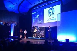 The 'outdoors' was the theme of this year's competition in the 2.009 Product Engineering Processes course. Here, a team demonstrates its plastic and fabric canopy designed to shield a bicyclist from rain.