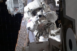 Astronaut Michael Fincke '89 captured this image of his own reflection during a spacewalk. The AMS, already installed on the International Space Station, is just behind him at top left.