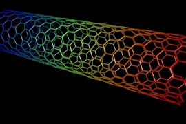 Graphic of a carbon nanotube, colored in rainbow colors on a black background