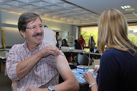 MIT Medical Senior Optician Roger Proulx received his annual vaccination.