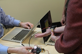 A MADMEC attendee tries out Wristify's thermoelectric bracelet.