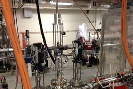 Photo shows a prototype device designed by the MIT team to produce a very narrow, high-powered beam of electrons for an experiment called DarkLight. The device was tested at the Jefferson National Accelerator Facility to confirm that it could meet the requirements needed to detect a hypothesized particle based on one theory about the nature of dark matter.