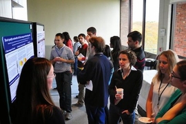 At the 2013 GCC Poster Session, PAOC's Rebecca Saari (left) presents her research on climate change policy. 