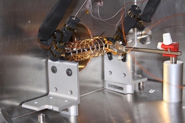 An open structure of copper wire surrounding a pipe was used in the
lab to measure how effective an electric field can be in pulling
droplets away from a condenser surface. In combination with a particular
kind of superhydrophobic surface, the new system can nearly double the
efficiency of the cooling process, the researchers found.