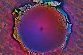 Scanning Electron Microscope (SEM) image shows region surrounding an indentation the MIT researchers made in a piece of shell from Placuna placenta. The image shows the localization of damage to the area immediately surrounding the stress.