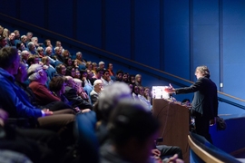 Bjorn Stevens demonstrates the greenhouse effect at the 2015 John Carlson Lecture at the Boston Aquarium.