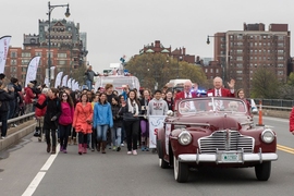 MIT's "Crossing the Charles" procession and competition was a featured part of the Institute's Moving Day festivities, May 7, 2016. Here, grand marshal Oliver Smoot '62 (right) rides at the front of the parade.

