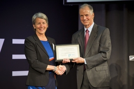 Elizabeth Sheehan, CEO of Climate Smart, receives the $10,000 grand prize from MIT professor and Climate CoLab founder Thomas Malone.