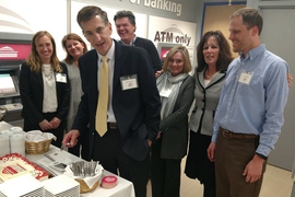 Members of the MIT Federal Credit Union executive team attend a re-opening reception on March 16. Left to right: Kim Mandola, senior vice president of member services; Lisa Mandel, vice president of information technology; Brian Ducharme, president/CEO; Scott Hanna, vice president of marketing; Cindy Hudson, chief financial officer; Nancy Fales, senior vice president of lending; and Kendall Nowoci...
