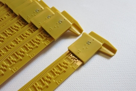 Plastic sliding calipers known as Squirrel Devices, developed by MIT grad students, make geometry’s continuous shapes and lengths measurable for blind and limited-vision students, who can read measurements in Braille.
