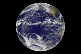 This image is a combination of cloud data from NOAA’s Geostationary Operational Environmental Satellite (GOES-11) and color land cover classification data. The Intertropical Convergence Zone is the band of bright white clouds that cuts across the center of the Earth. 