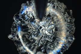 MIT researchers have found a surprising new twist to the mechanics involved when droplets come in contact with surfaces. Pictured here is a microscopic top view of a droplet.
