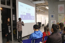 GSL-Peru students April Baker of MIT Sloan (left) and Dalitso Banda of EECS give a talk.