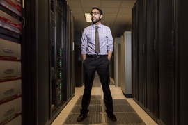 Vijay Gadepally stands in Lincoln Laboratory's in-house supercomputing center. Gadepally is part of a team that leveraged supercomputing to address cybersecurity issues. 