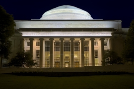 Photo of MIT Building 10 lit up at night