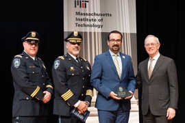 2019 Collier Medal recipient Arman Rezaee (second from right), MIT PhD candidate in the Department of Electrical Engineering and Computer Science, receives his award from Captain Craig Martin (left), MIT Police Chief John DiFava (second from left), and President L. Rafael Reif.