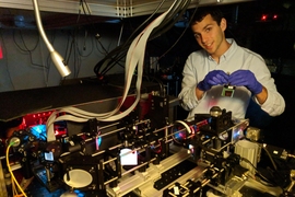 Dylan Cable prepares the Adaptive Upright Microscope, which will ultimately enable deeper imaging of animal brains.