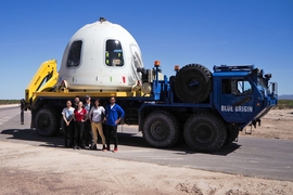 MIT Media Lab researchers (l-r) Xin Liu, Felix Kraemer, Ariel Ekblaw, Pete Dilworth, Rachel Smith, and Harpreet Sareen stand in front of the Blue Origin capsule holding their six payloads.