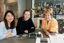 Left to right: Postdoc Shu Fen Tan, graduate student Kate Reidy, and Professor Frances Ross, all of the Department of Materials Science and Engineering, sit in front of a high vacuum evaporator system. 