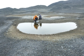 Marc Shallenberg samples from a pond.
