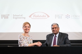 Anantha Chandrakasan, dean of MIT's School of Engineering (right), and Anne Heatherington, senior vice president and head of Data Sciences Institute at Takeda, at the ceremonial signing for the establishment of the MIT-Takeda Program