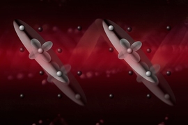 Researchers confirmed the existence of electronic waves that are frozen at a transition temperature of 125 kelvins and start “dancing together” in a collective oscillating motion as the temperature is lowered. In this illustration, a red laser beam triggers the dance of the newly discovered electronic waves in magnetite.
