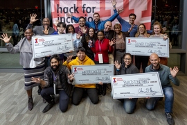 The three winning teams from the Hack for Inclusion 2020 and the crowd's favorite pose with their checks. 