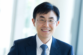 Headshot of In Song Kim, wearing a suit and tie