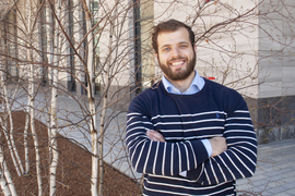 Portrait photo of Theo Mouratidis on MIT campus standing near young birch trees.