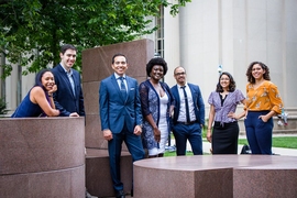 Photo of seven students standing casually outdoors