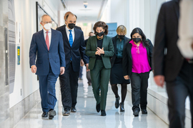 Members of the tour walk down an MIT.nano hallway