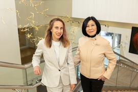 Portrait photo of Polina Anikeeva and Lisa Yang standing together in a stairwell