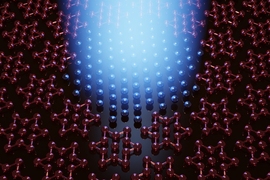 Realistic graphic showing an array of star-shaped atomic models illuminated by a central blue light. Where light shines, the models are replaced by standalone spheres.
