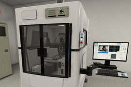 Virtual reality depiction of a die bonder machine, which looks like a large white box with a window looking into protected machinery. An attached arm holds a desktop computer screen and keyboard. 